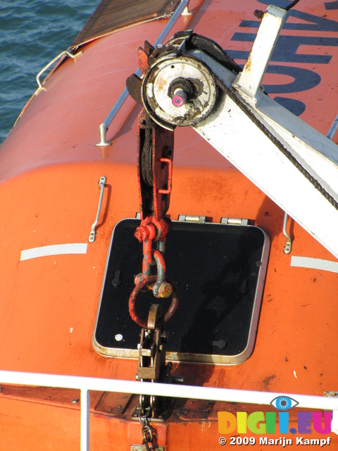 SX03027 Detail of crane holding orange lifeboat